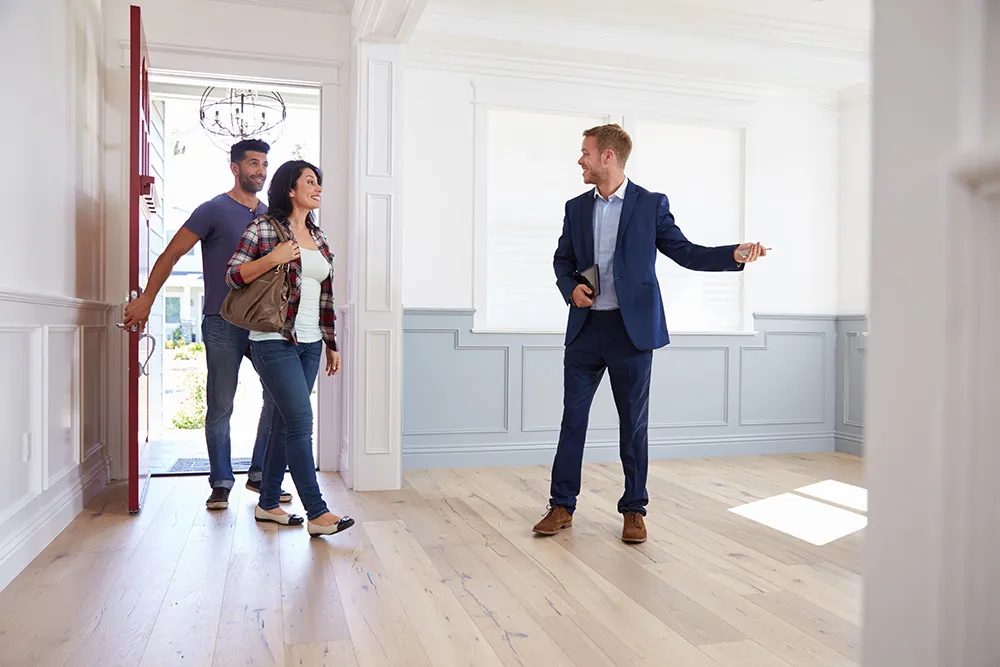Agent showing prospective tenants the house.